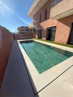 a swimming pool in front of a house at Exceptional Villa Private Pool and Breakfast in Marrakech