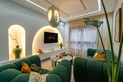 a living room with green couches and a tv at New! Maya House - Pool - Netflix - Gueliz in Marrakech