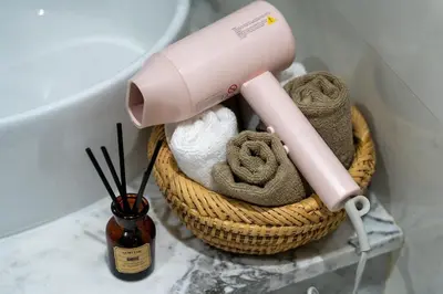a pink blow dryer in a basket next to a toilet at New! Maya House - Pool - Netflix - Gueliz in Marrakech