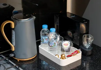a coffee maker and bottles of water on a counter at New! Maya House - Pool - Netflix - Gueliz in Marrakech