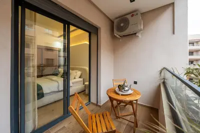 a room with a balcony with a table and a bed at New! Maya House - Pool - Netflix - Gueliz in Marrakech