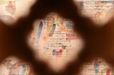 a view of a building through a window at Riad House of Calligraphy Marrakech in Marrakech