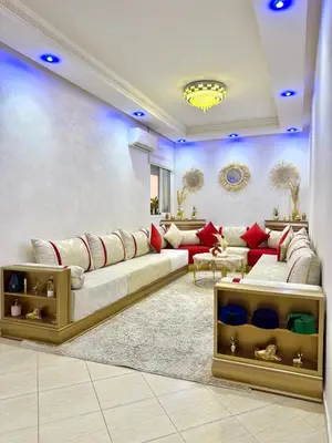 a living room with a large couch and red furniture at Appartement Artiste in Marrakech