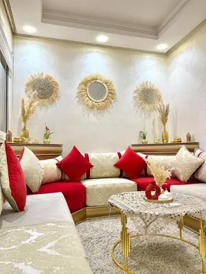 a living room with a red couch and a table at Appartement Artiste in Marrakech