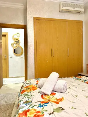 a bedroom with a bed with towels on it at Appartement Artiste in Marrakech