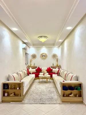 a living room with a red couch in a room at Appartement Artiste in Marrakech