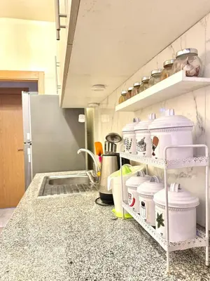 a kitchen with white shelves and a counter top at Appartement Artiste in Marrakech