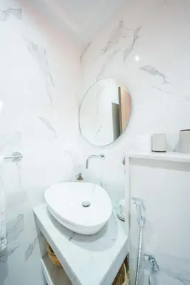 a white bathroom with a sink and a mirror at Modern apartments, cozy residence, swimming pools in Marrakech