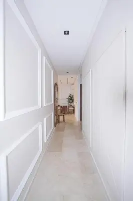 a hallway of a house with white walls and tile floors at Modern apartments, cozy residence, swimming pools in Marrakech