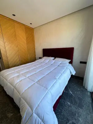 a bedroom with a large white bed in a room at new modern elite II apartment in Marrakech