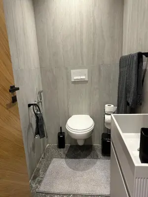 a bathroom with a white toilet and a sink at new modern elite II apartment in Marrakech