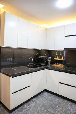 a kitchen with white cabinets and a sink at new modern elite II apartment in Marrakech