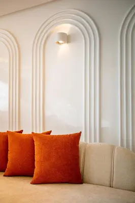 a couch with orange pillows in a room at Luxury Apartment In Majorelle Downtown Speed Wi-Fi and AC Calm in Marrakech