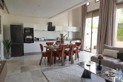 a kitchen and living room with a table and chairs at Mamounia loft by M&I in Marrakech