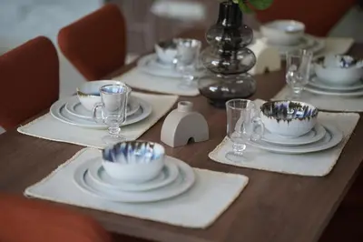 a wooden table with plates and bowls and glasses at Mamounia loft by M&I in Marrakech