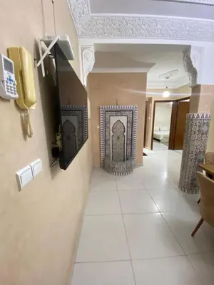 a hallway with a tile floor and a wall with a fireplace at Apartment in Marrakech Mabrouka in Marrakech