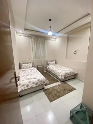 a room with two beds in a room with at Apartment in Marrakech Mabrouka in Marrakech