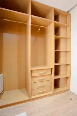 an empty closet with wooden shelves and cabinets at The Maison Épure - Marrakesh - Prestigia in Marrakech