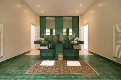 a bathroom with a sink and a mirror at Villa Primerose in Marrakech