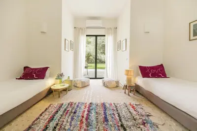 a living room with two beds and a rug at Villa Primerose in Marrakech