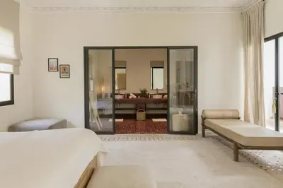 a bedroom with a bed and a living room at Villa Primerose in Marrakech