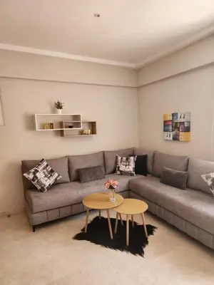 a living room with a couch and a table at Le Cosy Carré Éden - Hypercentre Gueliz in Marrakech