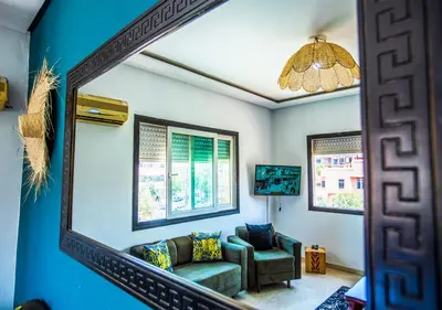 a mirror in a living room with a couch and a chair at Appart du centre 9 in Marrakech