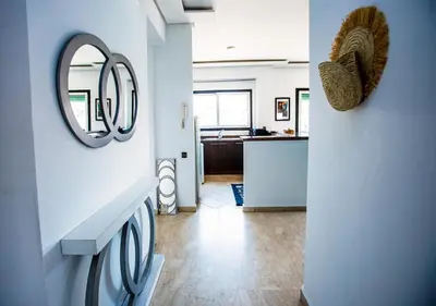 a laundry room with a sink and a mirror at Appart du centre 9 in Marrakech