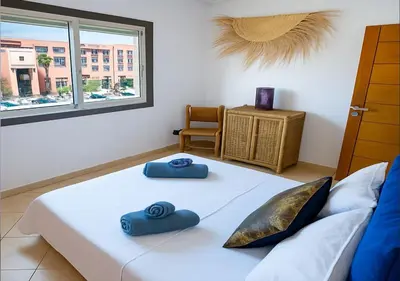 a bedroom with a bed with blue towels on it at Appart du centre 9 in Marrakech