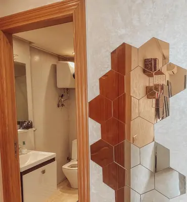 a bathroom with a toilet and a wall at Central Station Cosy Studio in Marrakech