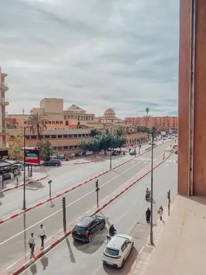 a city street with cars parked on the road at Central Station Cosy Studio in Marrakech