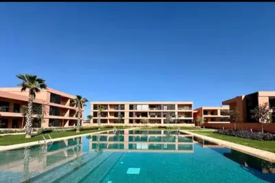 a large swimming pool in front of a building at Luxueux Appartement rez-de-chaussée Noria Golf in Marrakech