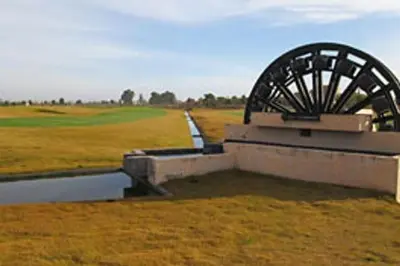 a watermill in the middle of a field at Luxueux Appartement rez-de-chaussée Noria Golf in Marrakech