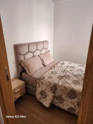 a bedroom with a bed with a headboard and pillows at Chic Urban Retreat Bright Apartment in Targa in Marrakech