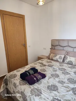 a bedroom with a bed with two pillows on it at Chic Urban Retreat Bright Apartment in Targa in Marrakech