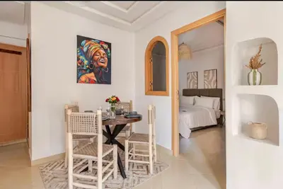 a room with a table and chairs and a bed at Rental unit in Marrakech in Marrakech