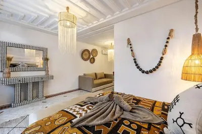 a living room with a bed and a fireplace at Riad Tigmmi - Exclusive - Pool - Free BF - 10 pax in Marrakech