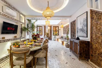 a living room with a table with food on it at Riad Tigmmi - Exclusive - Pool - Free BF - 10 pax in Marrakech