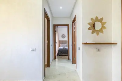 a hallway of a house with a mirror on the wall at Familial appt-Prestigia- 2BR-Pool-Free parking in Marrakech