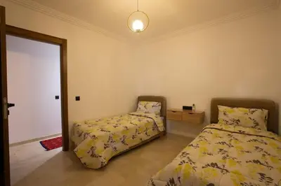 a bedroom with two beds and a mirror at Modern Oasis in Heart of Guéliz Pool Balcony in Marrakech
