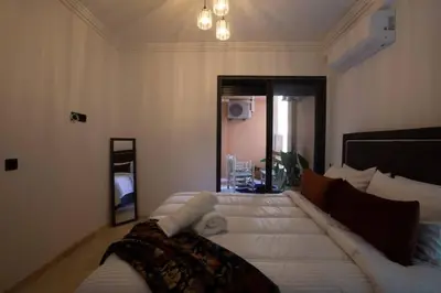 a large white bed in a room with a mirror at Modern Oasis in Heart of Guéliz Pool Balcony in Marrakech
