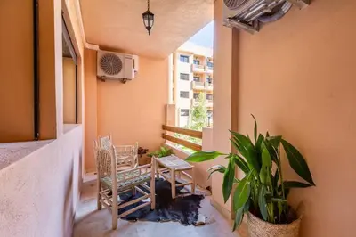 a balcony with chairs and a table and a plant at Modern Oasis in Heart of Guéliz Pool Balcony in Marrakech