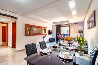 a living room with a table and a couch at Menara gardens in Marrakech