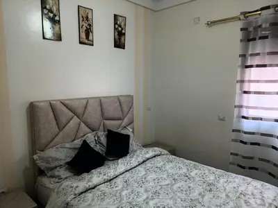 a bedroom with a bed with two pillows on it at Marrakech in Marrakech