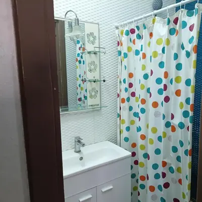 a bathroom with a sink and a shower curtain at Marrakech in Marrakech