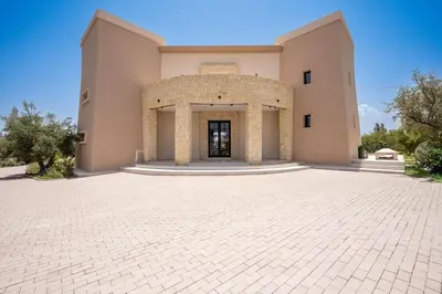 a large building with a brick driveway in front of it at MIKESTAY Domaine ATIKA in Segraga