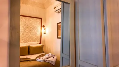a room with a mirror and a bed in a room at Riad Tamazy in Marrakech