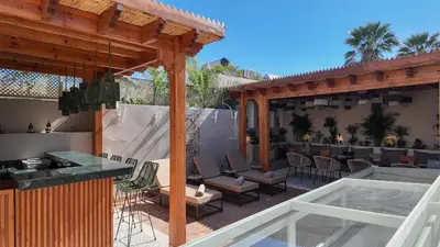 a patio with a bar and chairs and a restaurant at Riad Tamazy in Marrakech