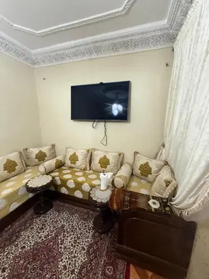 a living room with a couch and a flat screen tv at Yassine in Marrakech