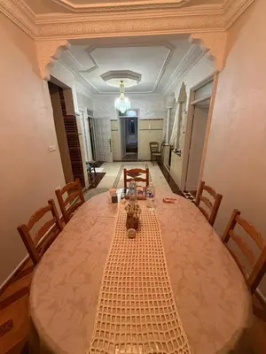 a dining room table with chairs and a long table at Yassine in Marrakech